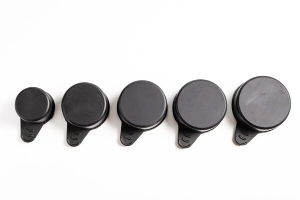 A row of black knobs on the wall.